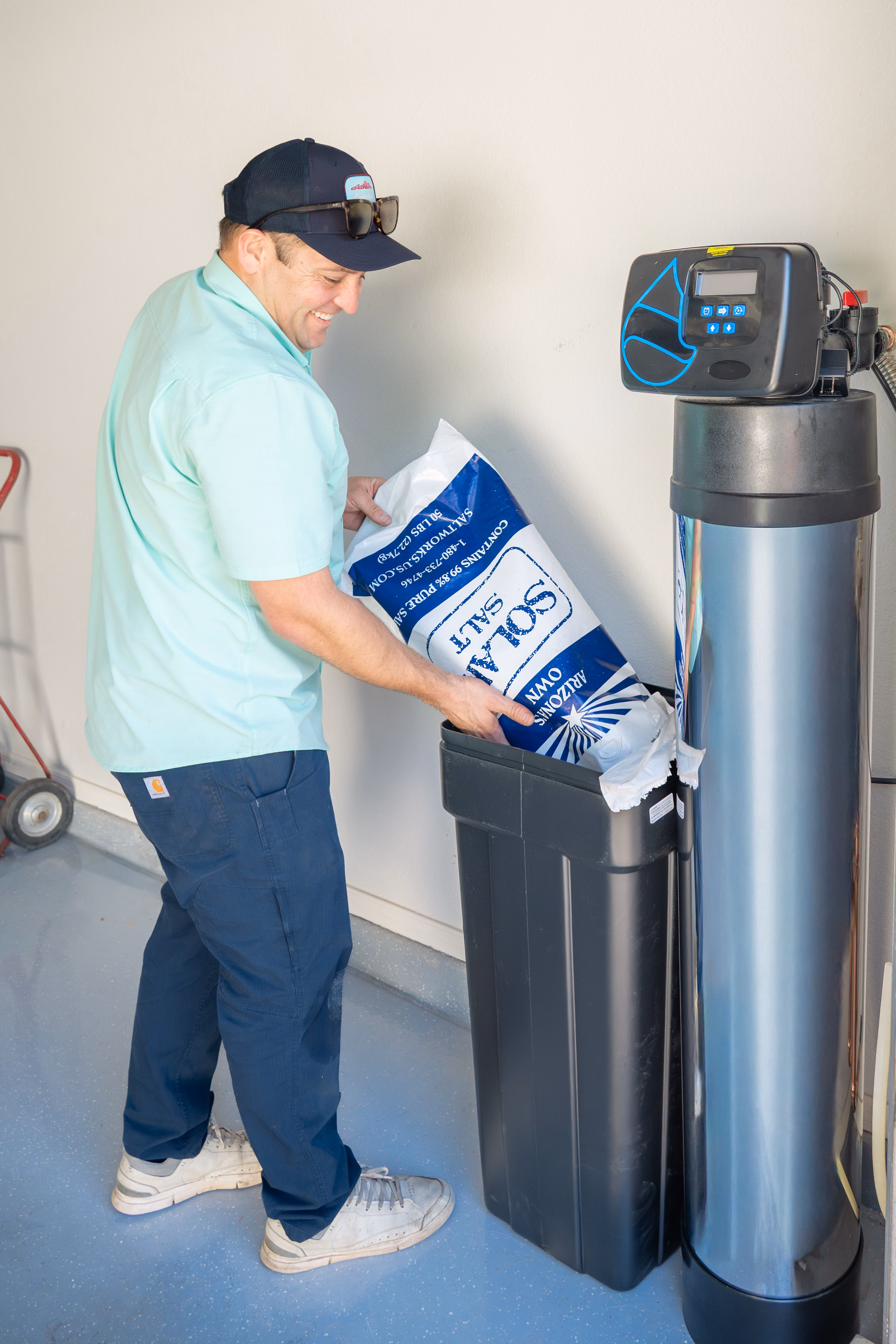 Gabe Sandersius working beside a home water-treatment system
