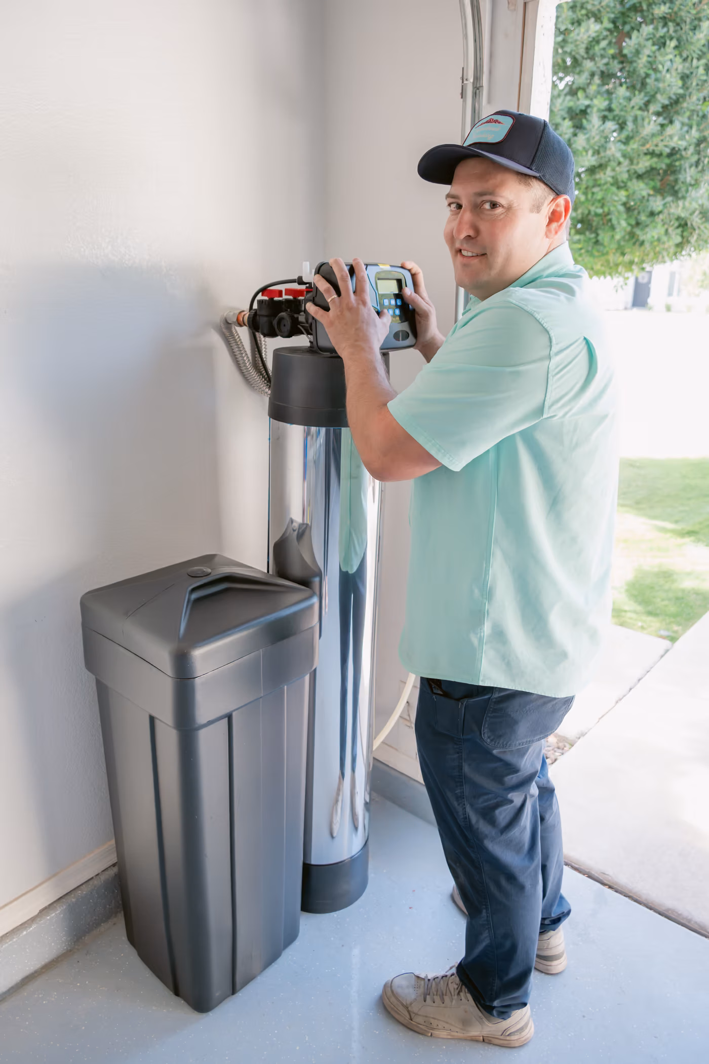 Gabe Sandersius working beside a home water system